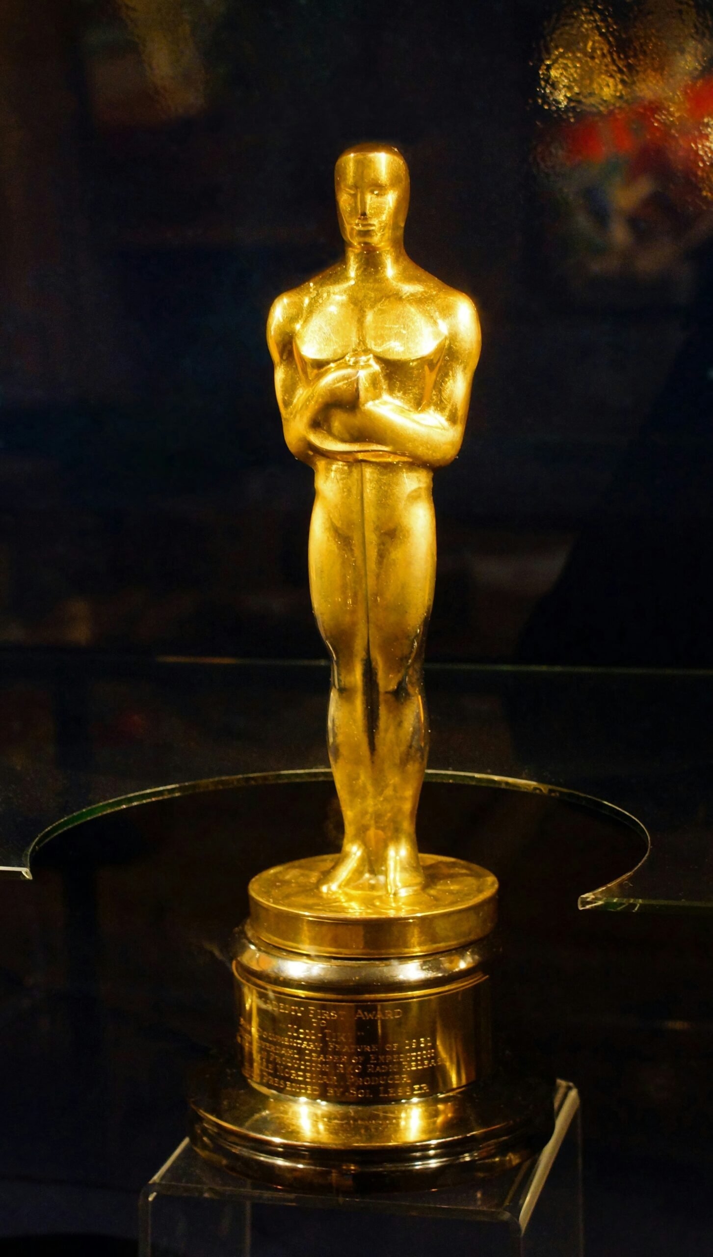 An oscar statue on display in a glass case